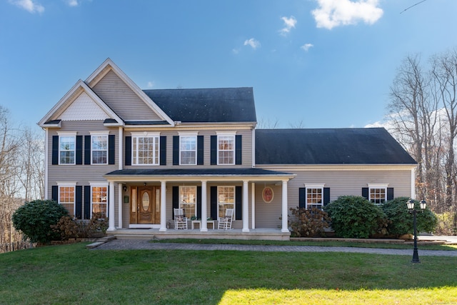 view of front of house with covered porch and a front yard