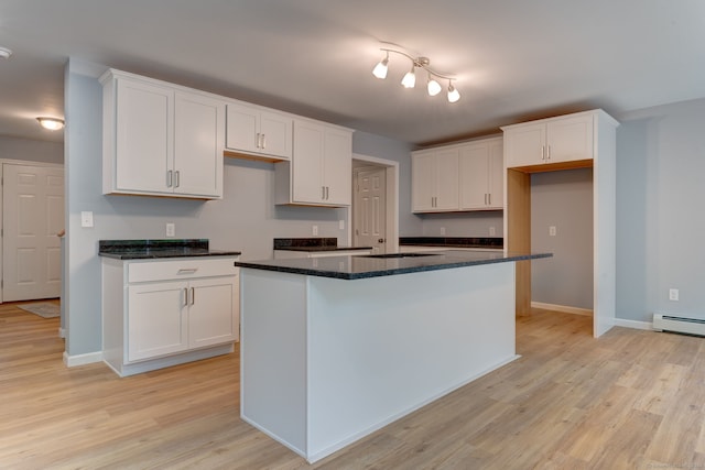 kitchen featuring white cabinetry, a kitchen island, and light wood-type flooring