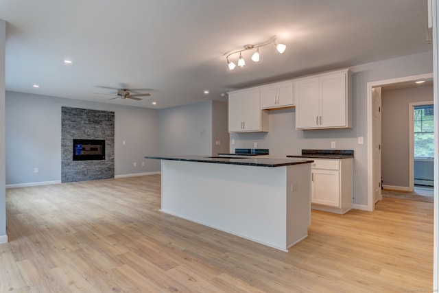 kitchen with light wood-type flooring and white cabinetry