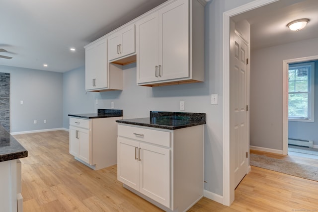 kitchen with white cabinetry, a baseboard radiator, and light wood-type flooring