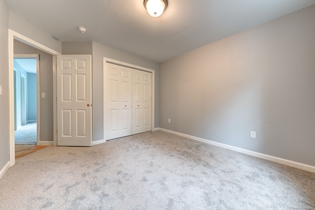 unfurnished bedroom with carpet and a closet