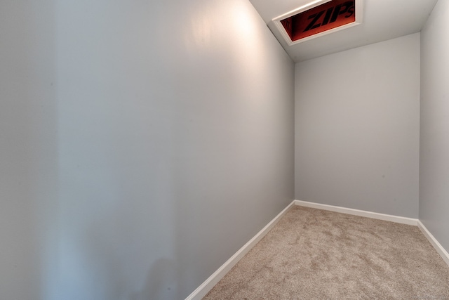 empty room featuring light colored carpet and lofted ceiling