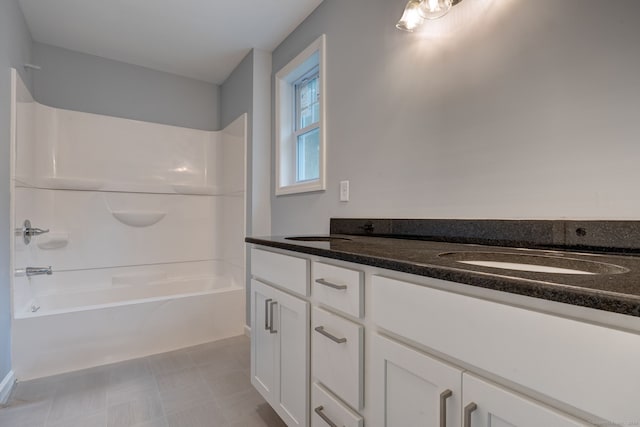 bathroom featuring vanity and  shower combination