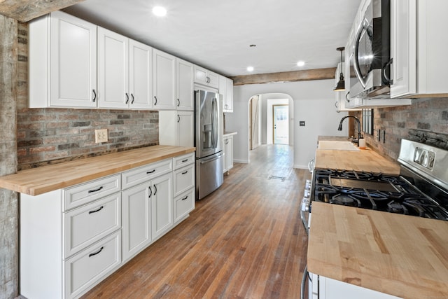 kitchen featuring butcher block countertops, white cabinetry, sink, and appliances with stainless steel finishes