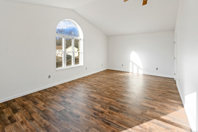 empty room featuring dark hardwood / wood-style flooring, vaulted ceiling, and ceiling fan