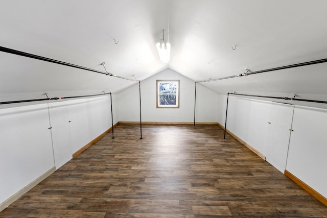 bonus room featuring dark hardwood / wood-style flooring and vaulted ceiling