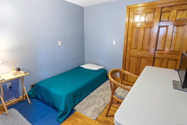 bedroom with hardwood / wood-style floors