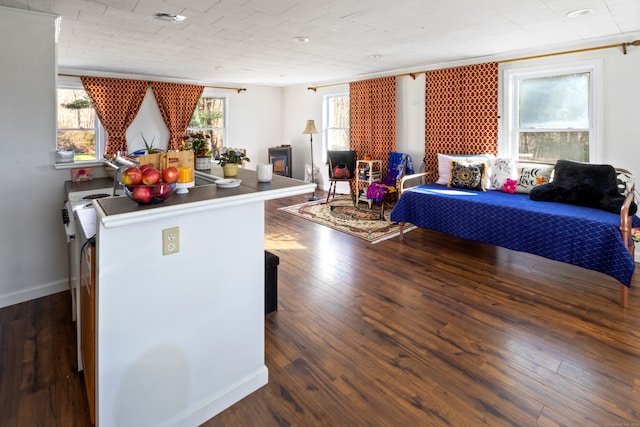 interior space with dark wood-type flooring and ornamental molding