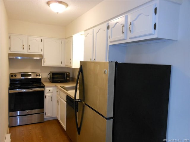 kitchen featuring stainless steel appliances, white cabinetry, and dark wood-type flooring