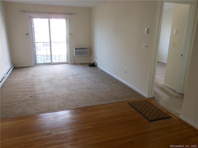 carpeted spare room with an AC wall unit