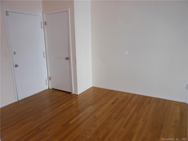 empty room with hardwood / wood-style flooring