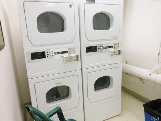 laundry room with stacked washer and clothes dryer and washer and dryer