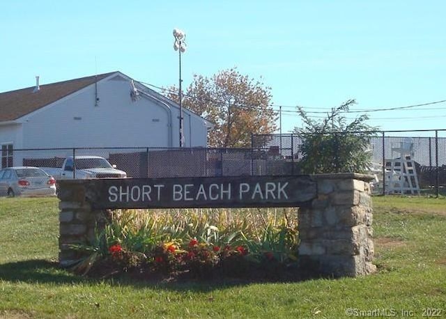 community / neighborhood sign with a lawn