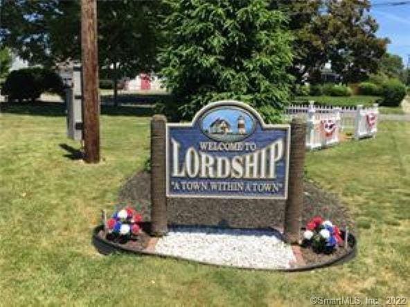 community / neighborhood sign with a lawn