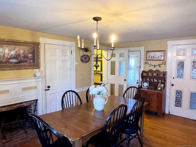 dining room featuring a fireplace and hardwood / wood-style flooring