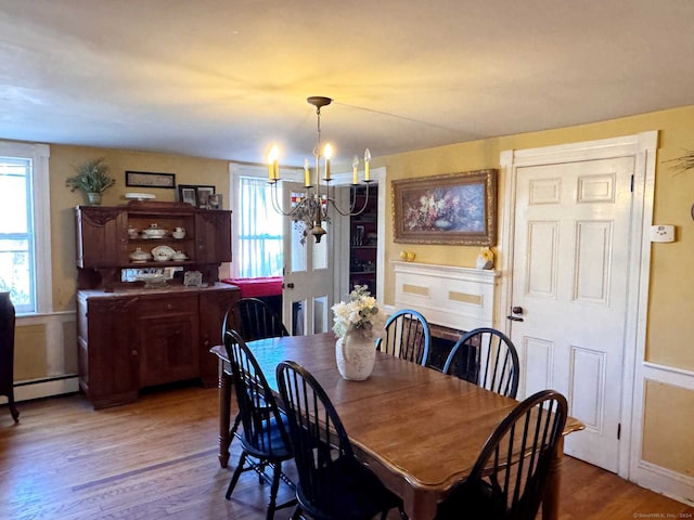 373 Main St, New Hartford, CT 06057 - dining space with a baseboard radiator, a chandelier, plenty of natural light, and wood finished floors