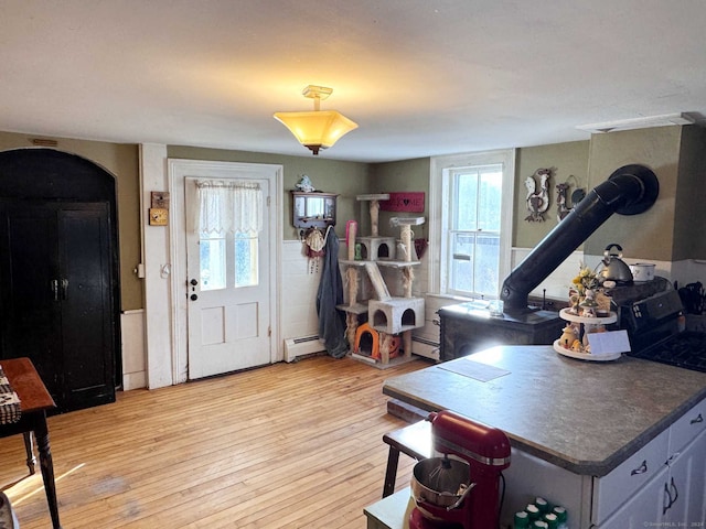 foyer with light hardwood / wood-style flooring and a baseboard heating unit