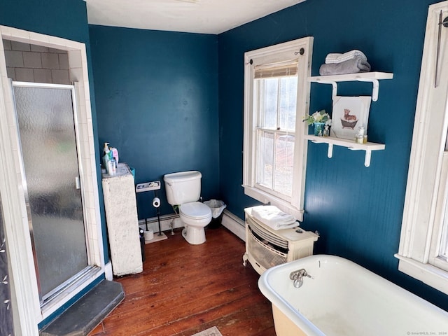 bathroom with plus walk in shower, wood-type flooring, a baseboard radiator, and toilet