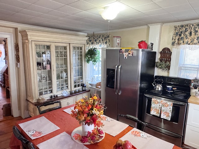 373 Main St, New Hartford, CT 06057 - kitchen featuring stainless steel appliances, ornamental molding, wood finished floors, and glass insert cabinets