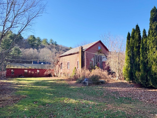 view of side of property with a lawn