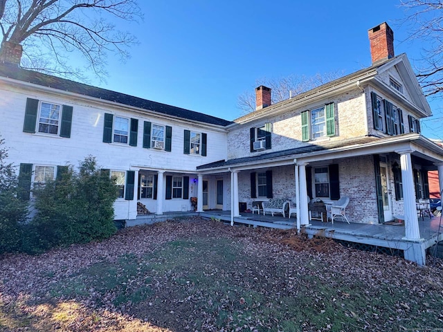 view of front of house with a porch and cooling unit