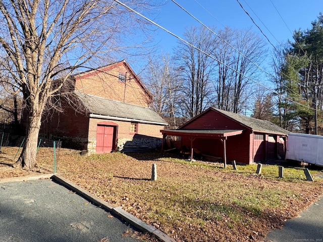 view of side of home with an outbuilding