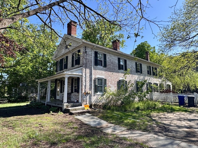 373 Main St, New Hartford, CT 06057 - colonial home with a chimney, a porch, brick siding, and fence