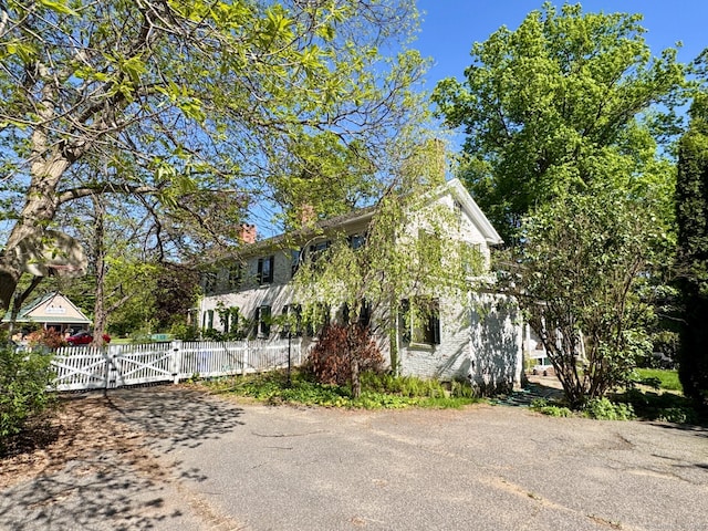 373 Main St, New Hartford, CT 06057 - view of property exterior featuring a gate, a chimney, and a fenced front yard