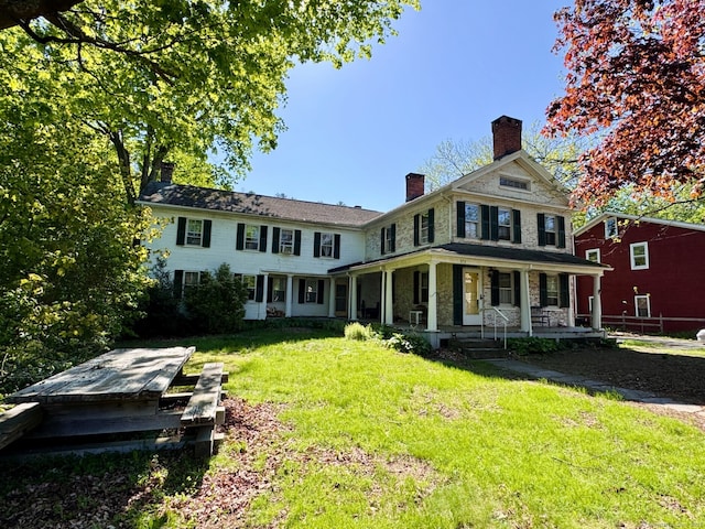 373 Main St, New Hartford, CT 06057 - rear view of house with a porch, a chimney, a lawn, and stone siding