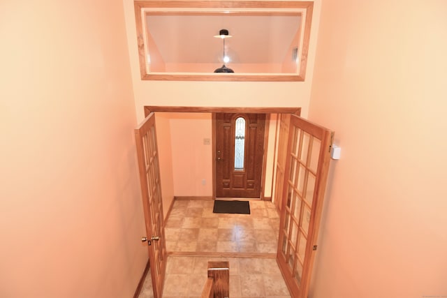 entryway with a tray ceiling