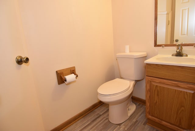 bathroom featuring hardwood / wood-style floors, vanity, and toilet