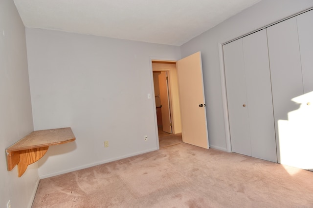 bedroom with a closet and light colored carpet