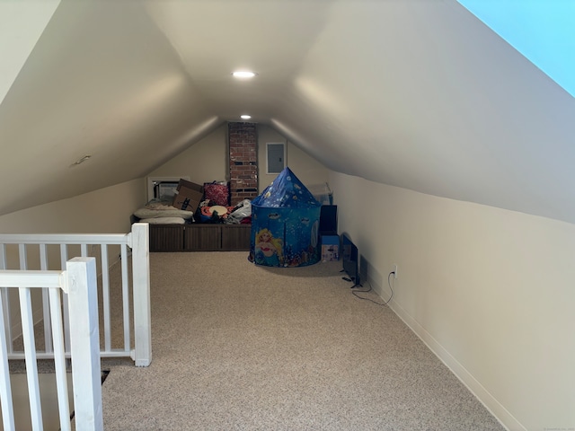 bonus room with carpet, lofted ceiling, and electric panel