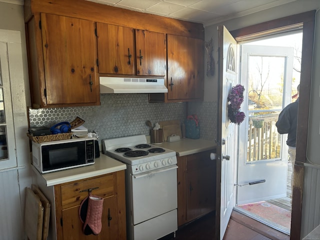 20 Middlesex Avenue Extension, Portland, CT 06480 - kitchen with white electric range oven, under cabinet range hood, brown cabinets, tasteful backsplash, and light countertops