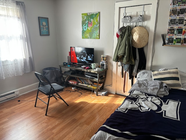 bedroom featuring wood-type flooring and a closet