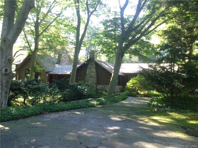 87 Red Coat Rd, Westport, CT 06880 - view of property exterior with a chimney and stone siding