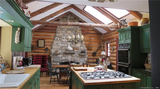 87 Red Coat Rd, Westport, CT 06880 - kitchen featuring rustic walls, green cabinetry, stainless steel gas cooktop, light wood-type flooring, and a center island