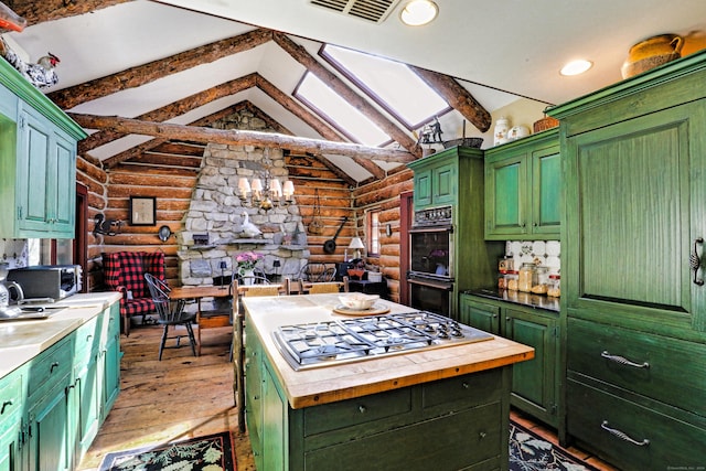 87 Red Coat Rd, Westport, CT 06880 - kitchen featuring rustic walls, stainless steel appliances, green cabinets, light wood-style flooring, and recessed lighting