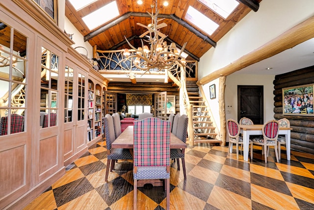 87 Red Coat Rd, Westport, CT 06880 - dining space featuring a chandelier, high vaulted ceiling, a skylight, stairs, and beam ceiling