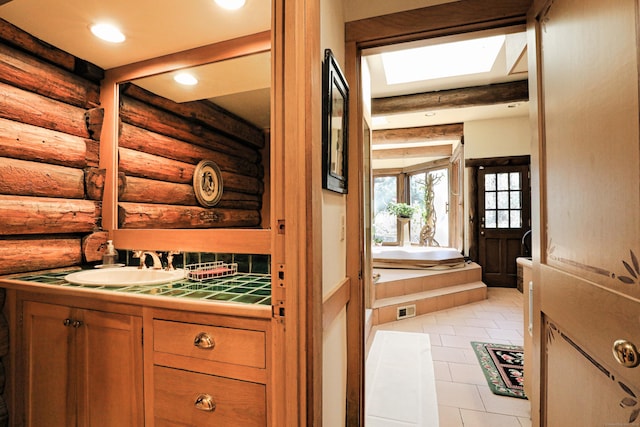 87 Red Coat Rd, Westport, CT 06880 - bathroom featuring log walls, vanity, a bath, tile patterned floors, and recessed lighting
