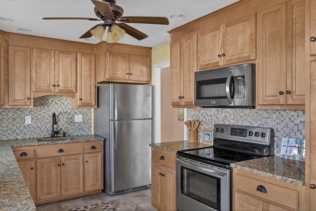 140 Salt Island Rd, Westbrook, CT 06498 - kitchen featuring appliances with stainless steel finishes, a sink, a ceiling fan, light stone countertops, and backsplash