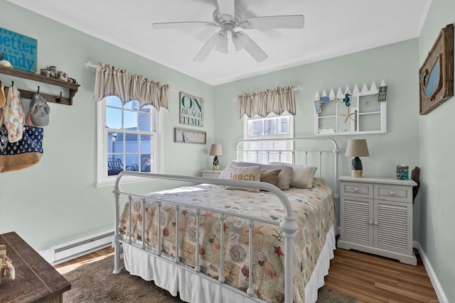 bedroom with ceiling fan, a baseboard radiator, and dark hardwood / wood-style floors