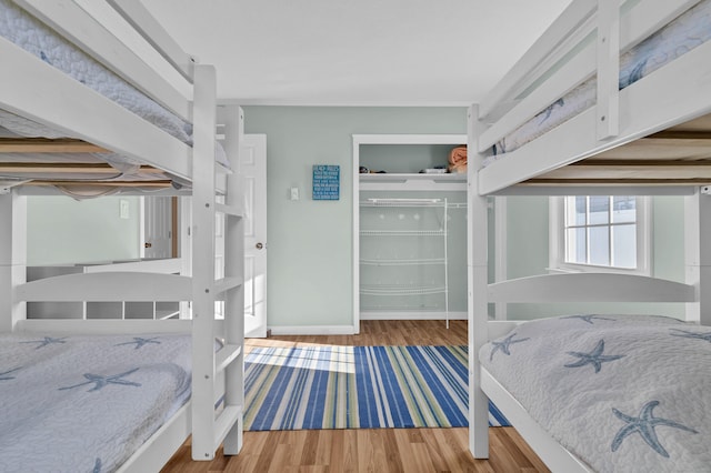 bedroom with wood-type flooring and a closet