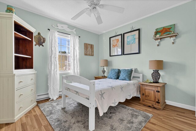 140 Salt Island Rd, Westbrook, CT 06498 - bedroom with light wood-style floors, baseboards, a ceiling fan, baseboard heating, and ornamental molding