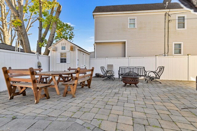140 Salt Island Rd, Westbrook, CT 06498 - fenced backyard featuring outdoor dining space, a patio, a fire pit, and an outdoor structure