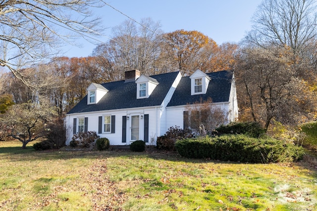 cape cod home with a front yard