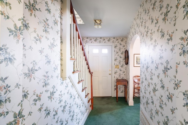 foyer featuring dark carpet