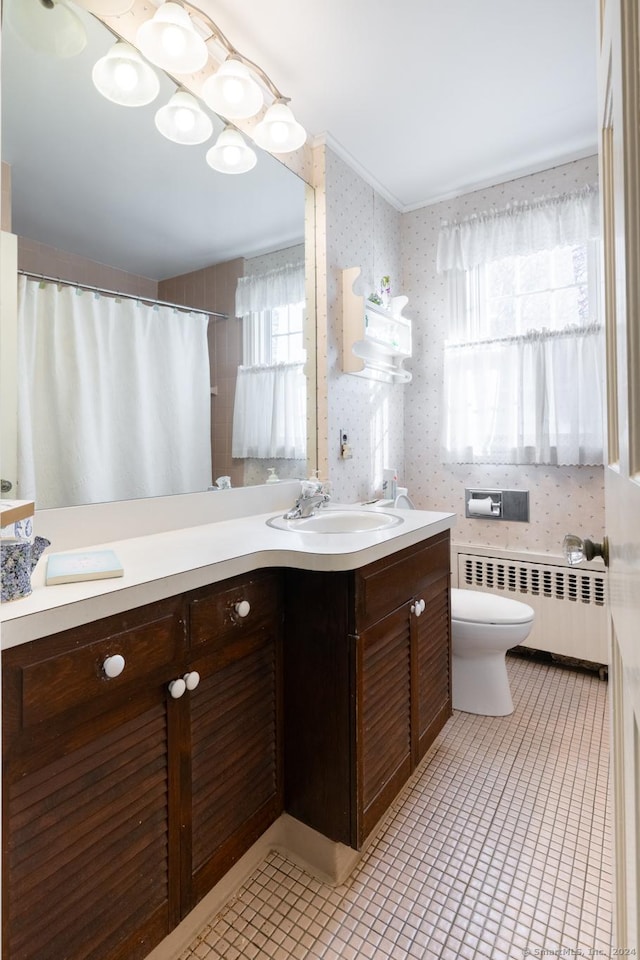 bathroom with toilet, a wealth of natural light, radiator heating unit, and tile patterned flooring