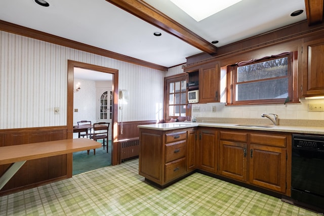 kitchen with beam ceiling, radiator, dishwasher, sink, and kitchen peninsula