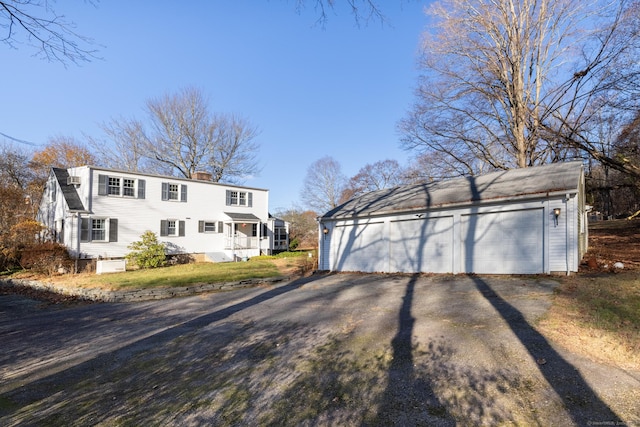 view of front of property featuring an outbuilding and a garage